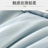 Close-up of a light blue, textured fabric blanket draped softly.