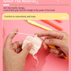 Hands are using aluminum plastic crochet hooks to work with white yarn on a pink background.