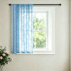 Light blue vintage French-style lace curtain hanging on a white window frame.
