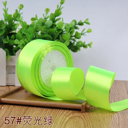 Roll of bright lime green satin ribbon for gift wrapping and DIY crafts