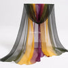 A display of flowing, sheer scarves in shades of green, yellow, and purple for sensory play.