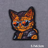 A black and orange embroidered patch of a cat wearing sunglasses.