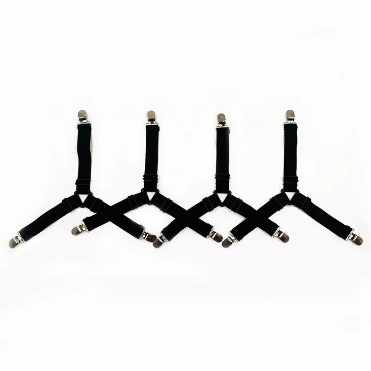 A set of black adjustable sheet corner grippers with elastic straps arranged in a line.