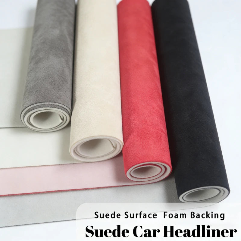 Rolls of suede fabric for car headliners with foam backing in gray, beige, red, and black.