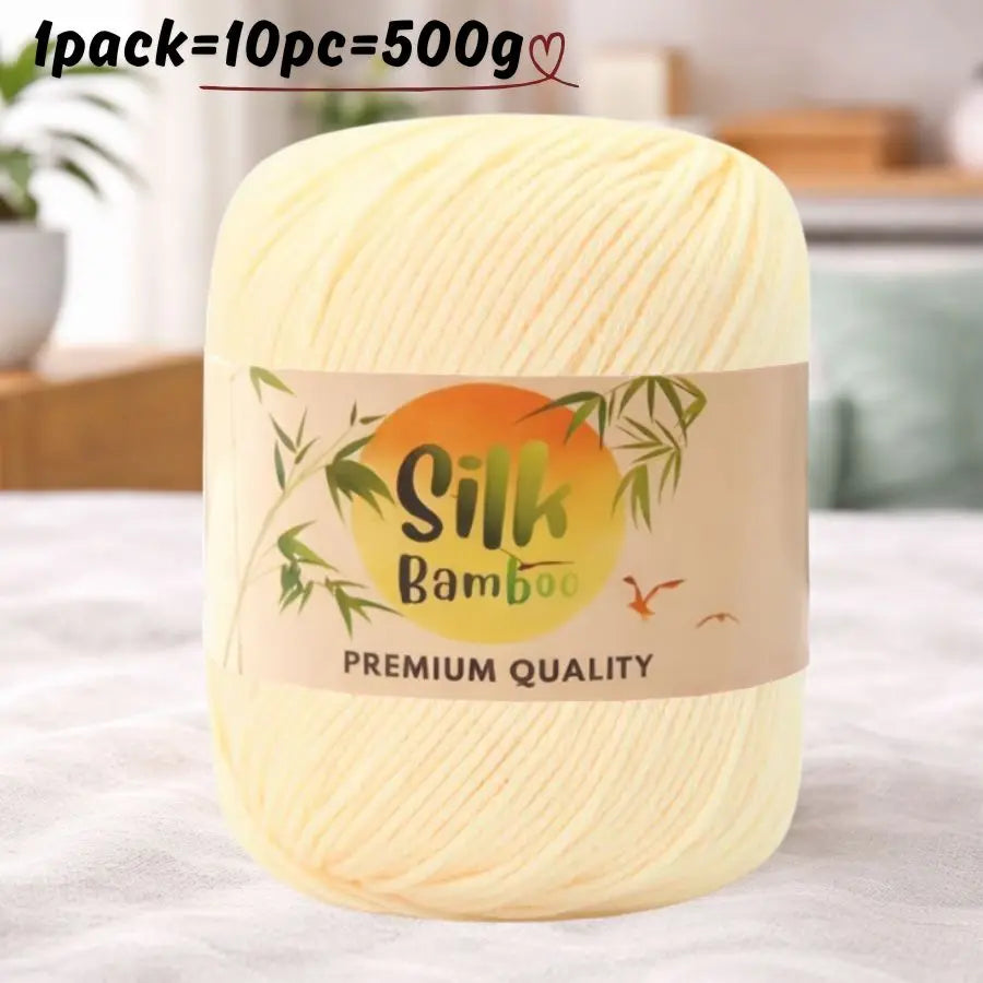 A ball of light yellow silk bamboo blend yarn labeled premium quality for knitting and crochet.