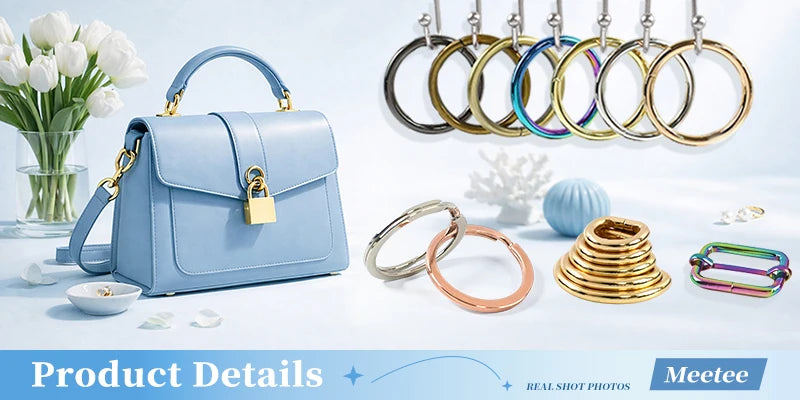 A collection of round metal rings and fabric-covered shank buttons displayed next to a light blue leather handbag.