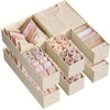 A cardboard organizer set containing various shades of pink and beige folded underwear.