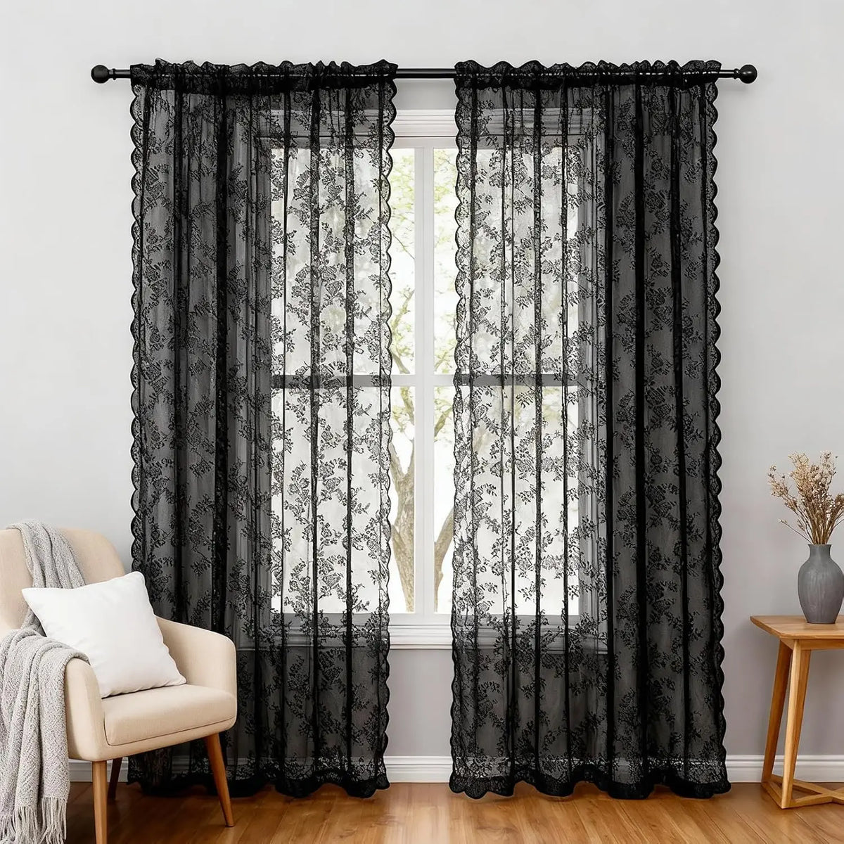 Black vintage floral lace sheer curtains hanging in a window frame
