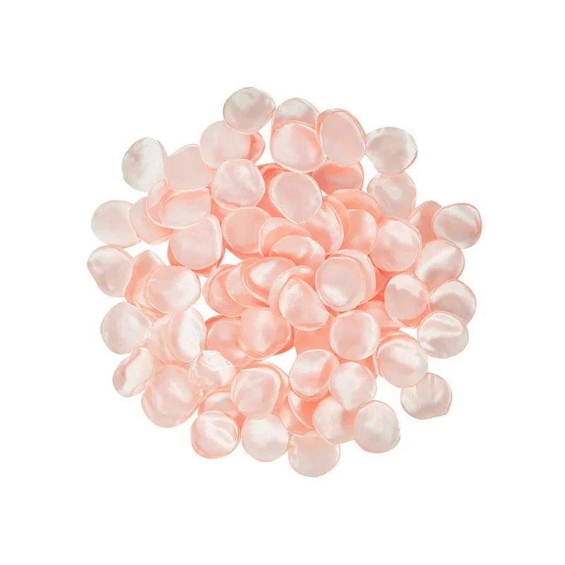 A pile of pink silk rose petals for weddings and events.