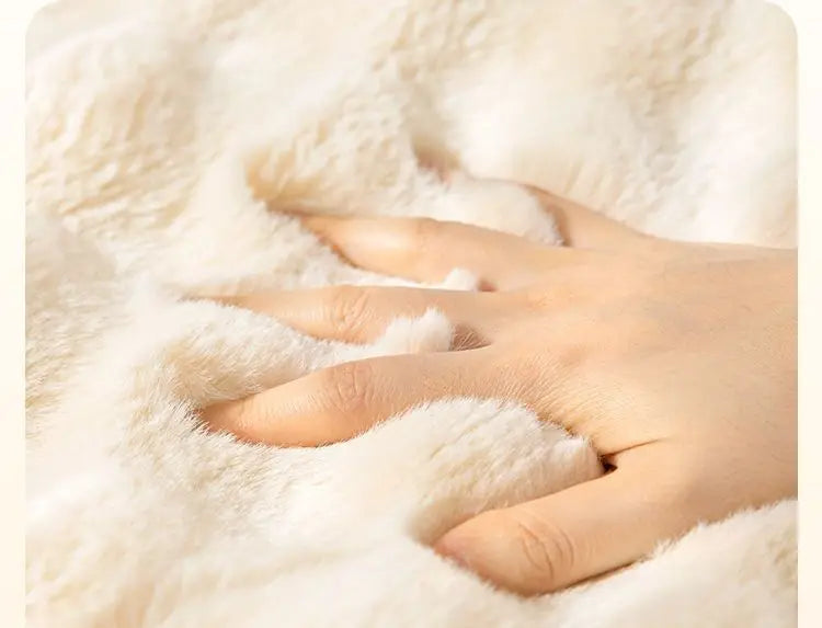 A hand is gently touching a fluffy white rabbit fur sofa cushion cover.