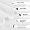 Close-up of a white microfiber throw blanket showing features like fluffiness, high quality stitching, and durability.