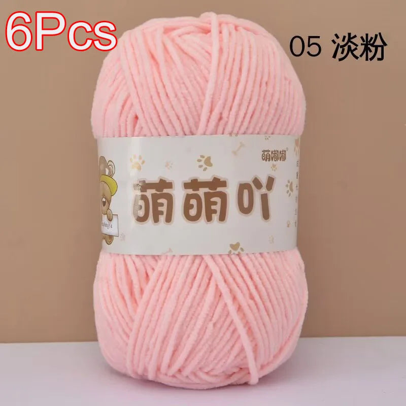 A skein of pink soft bulky chenille yarn is shown, packaged for crochet and knitting projects.