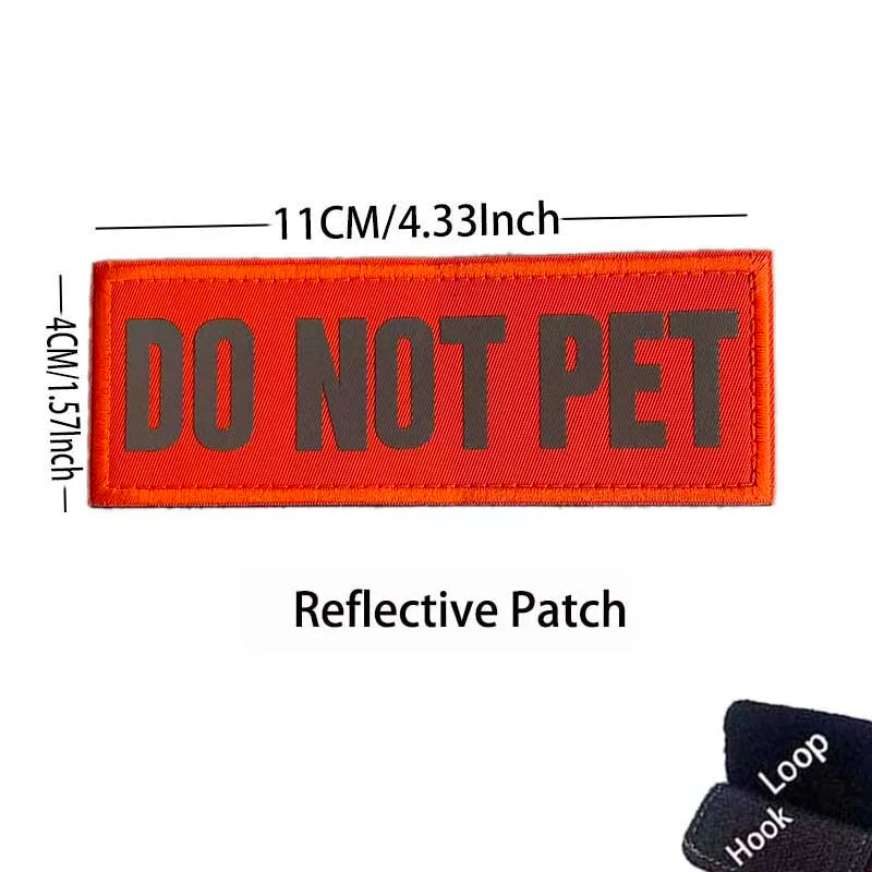 An orange reflective patch embroidered with the text DO NOT PET