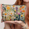 A floral canvas cosmetic bag with a zipper closure featuring various colorful flowers and greenery.