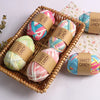A woven basket filled with pink, blue, and white hand-dyed fabric strip yarn balls labeled Sweet Candy.