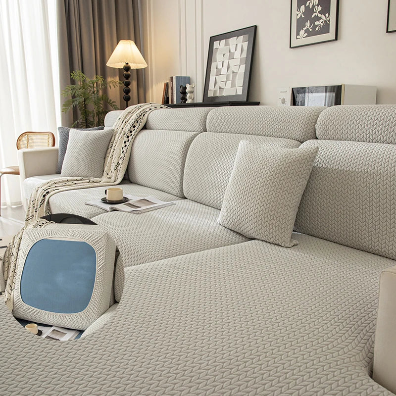 A light beige plush elastic sofa cushion cover displayed on a modern sofa with neutral decor.