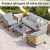 Gray outdoor sofa cushion covers protecting wicker patio furniture in a garden setting.