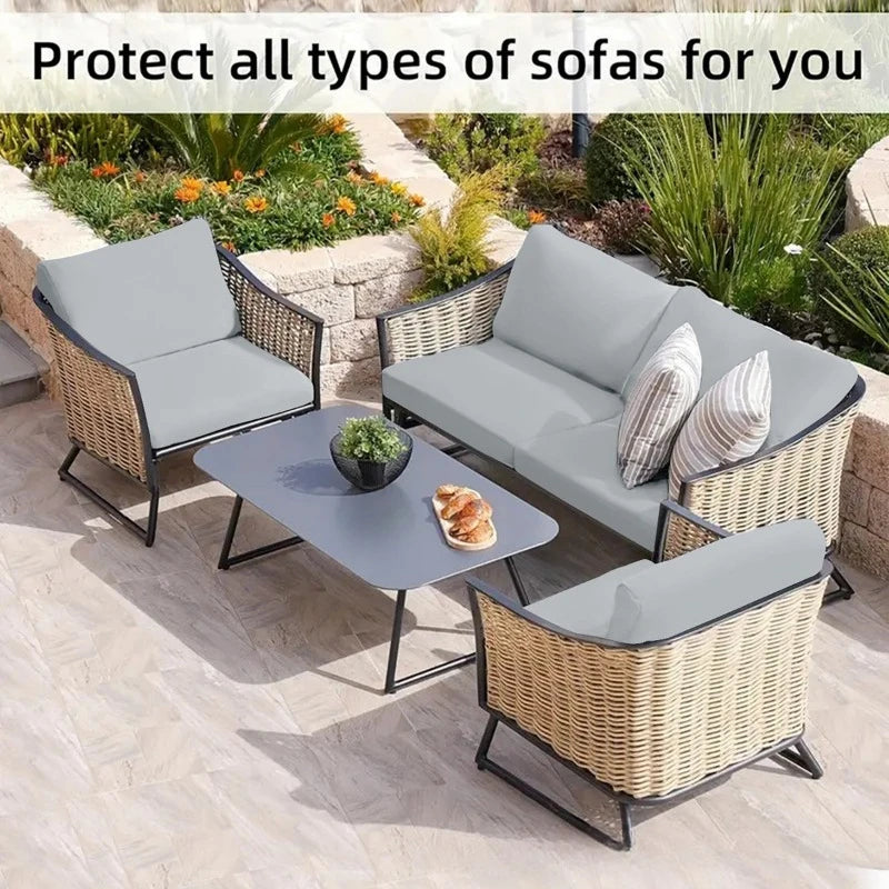 Gray outdoor sofa cushion covers protecting wicker patio furniture in a garden setting.