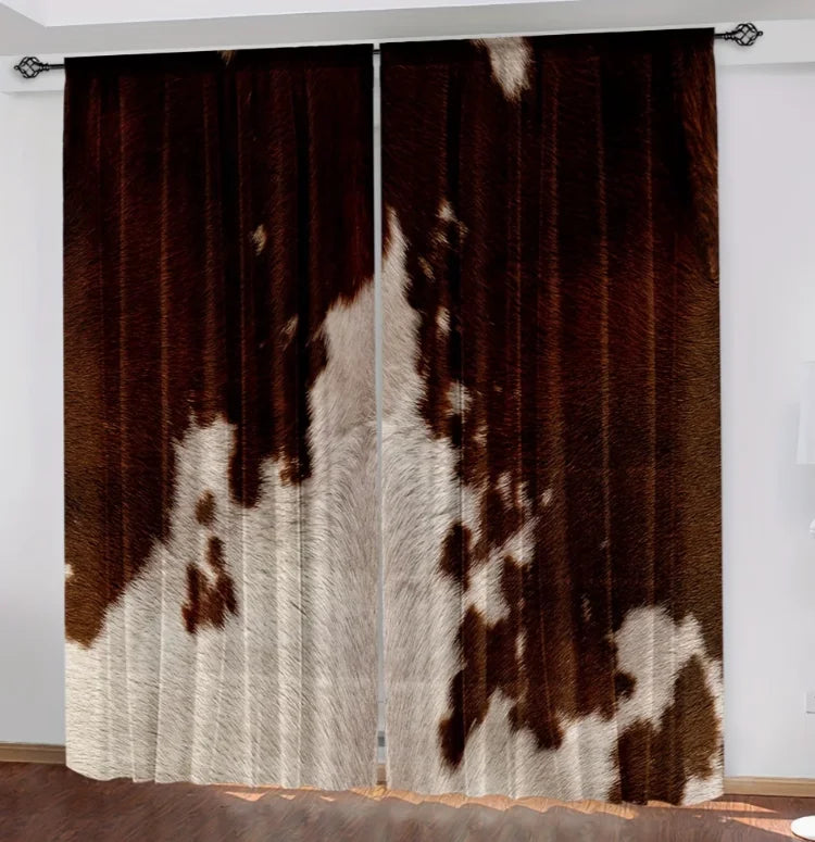A pair of brown and white cow print curtains hanging in a doorway.