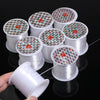 Rolls of precision nylon beading thread for jewelry making stacked on a black surface.