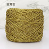 A ball of metallic gold silk yarn used for crocheting and knitting.