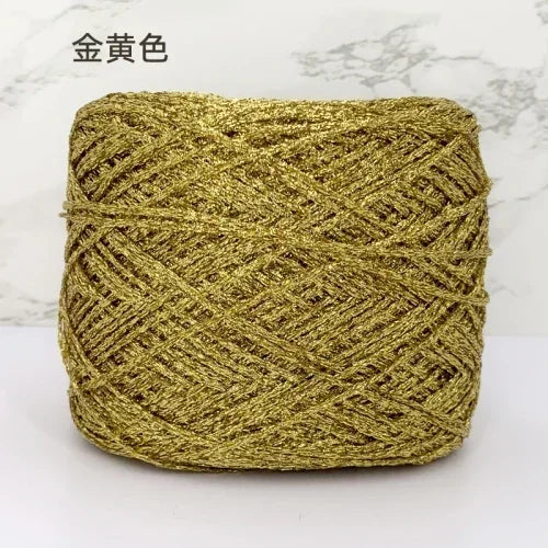 A ball of metallic gold silk yarn used for crocheting and knitting.