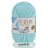 A ball of light blue milk cotton yarn with a label featuring a cow and the text Milk Cotton.