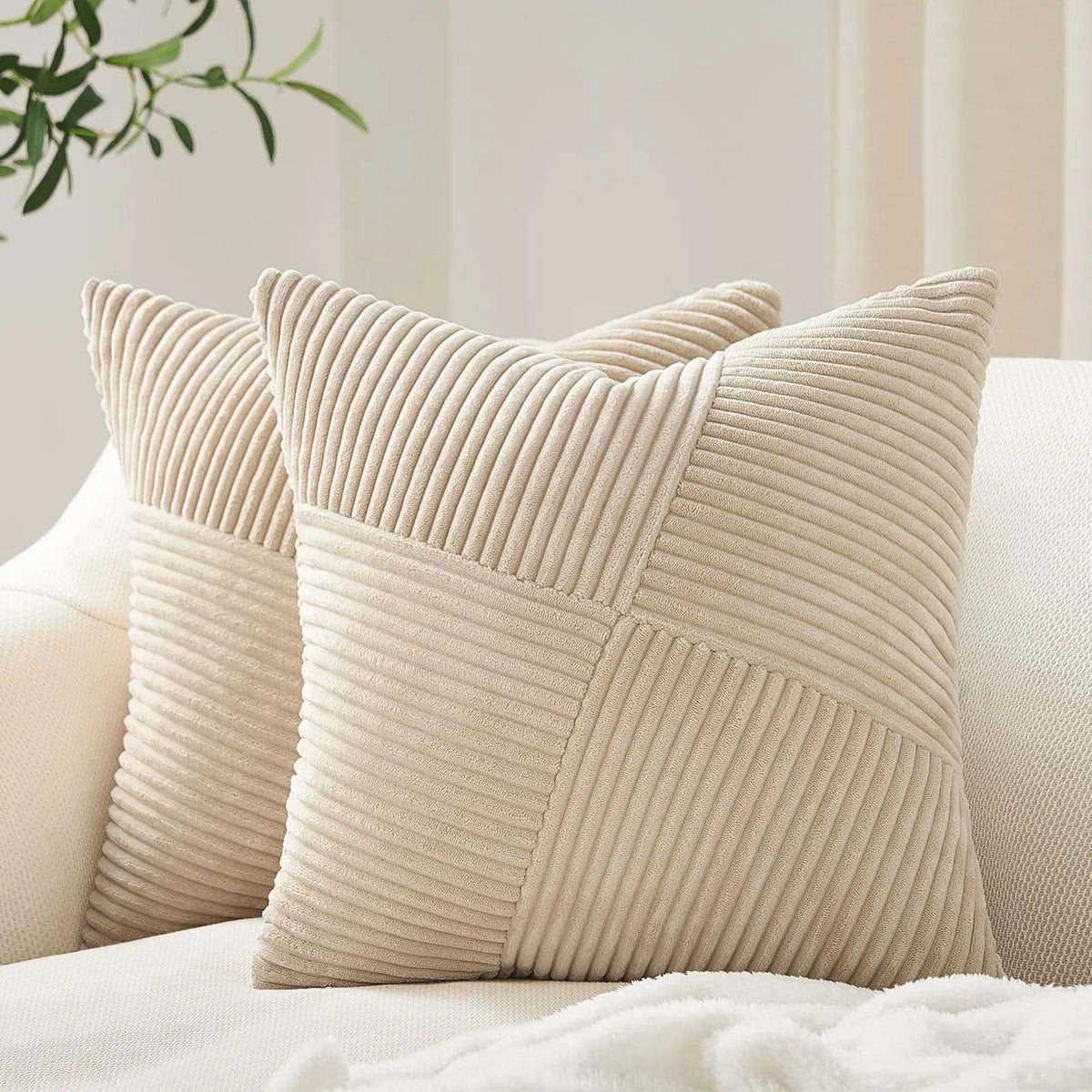 A beige textured corduroy throw pillow cover with a diamond pattern resting on a white surface.