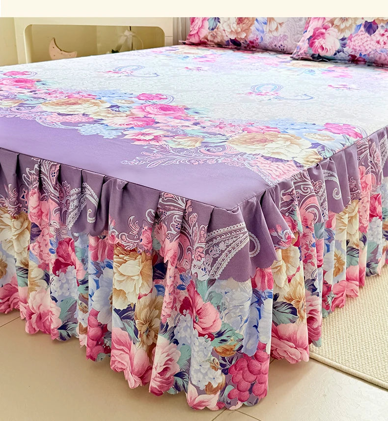 A purple and pink floral print bed skirt set with a matching duvet cover on a bed.