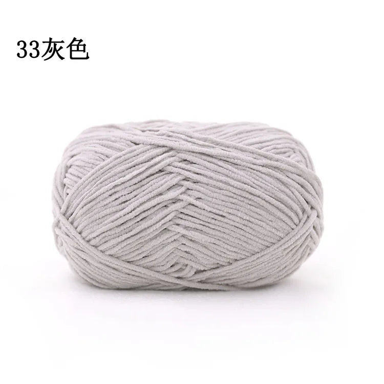 A ball of light gray 3mm matte chenille yarn for knitting and crochet.