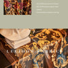 Close-up of a luxurious fabric featuring gold and blue floral embroidery, displayed next to a white plaster bust.