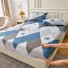 A blue and gray floral fitted sheet set with matching pillowcases is displayed on a bed.
