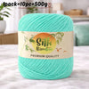 A skein of bright turquoise silk bamboo blend yarn is shown on a white surface.