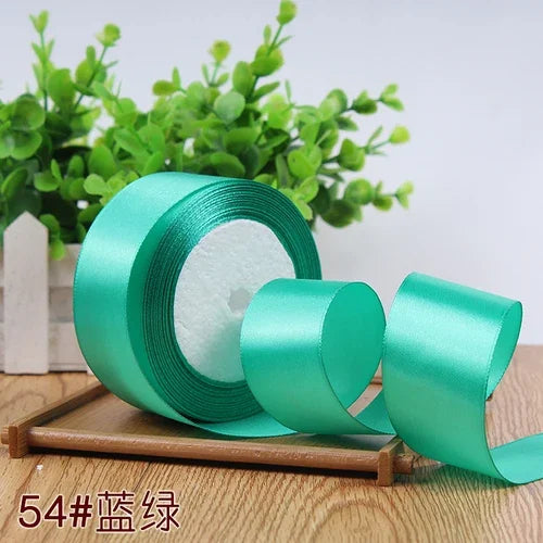 Roll of 4 cm wide satin ribbon in mint green for gift wrapping and DIY crafts