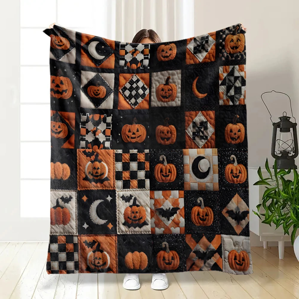 A patchwork flannel throw blanket featuring an orange and black Halloween design with carved pumpkins and bats.