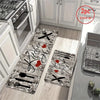 A rectangular kitchen mat featuring a heart design with crossed cutlery on a light wood floor.