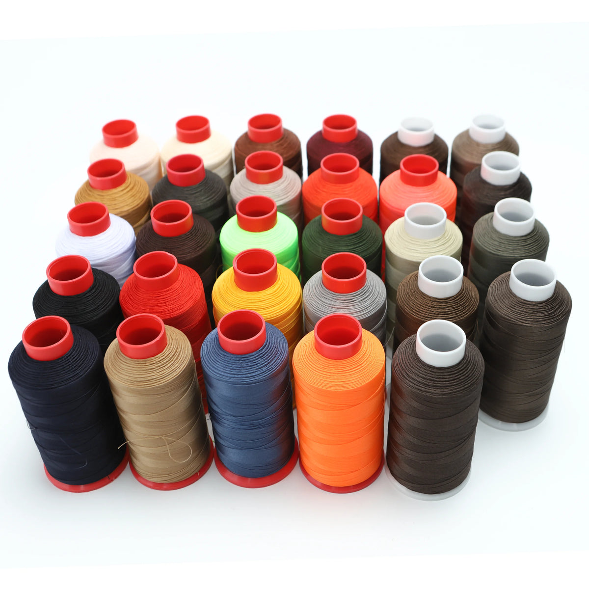 A collection of various colored heavy duty nylon sewing thread spools arranged in a row.