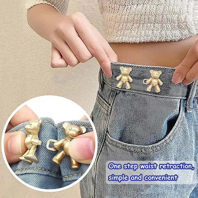 Close-up of bear button pins being used to tighten the waist of denim jeans