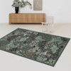 A dark botanical area rug featuring green and brown foliage in a living room setting.