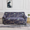 A navy blue stretch floral elastic sofa cover featuring a geometric pattern on a gray rug.