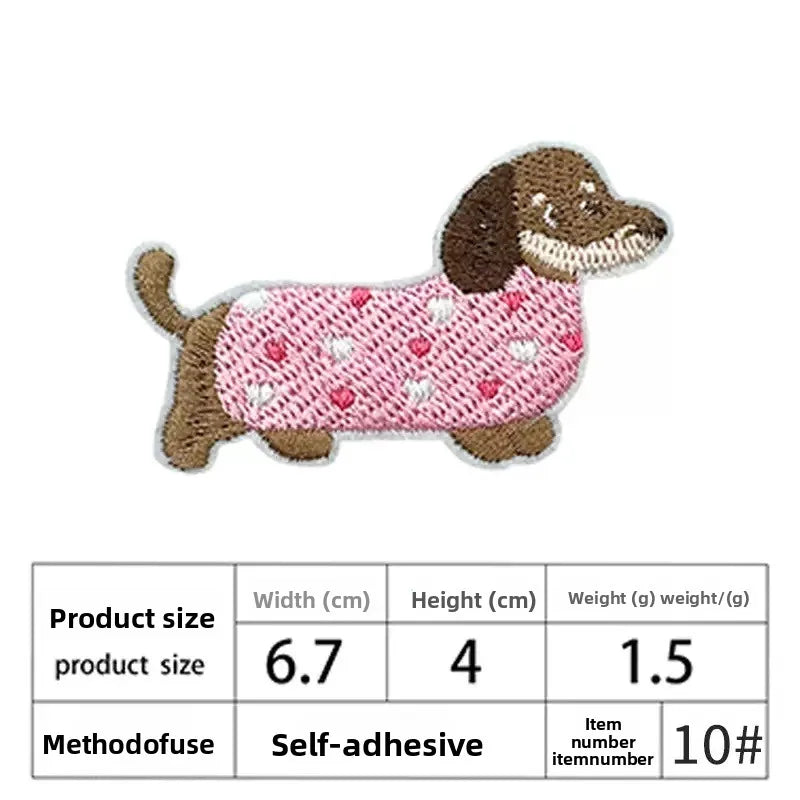 A pink embroidered patch shaped like a dog with brown ears and a dark body.