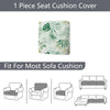 A single floral outdoor sofa cushion cover in a light green and white pattern shown next to various sofa cushions.