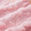 Close-up texture of pink faux fur pillow covers showing soft fibers and stitching.