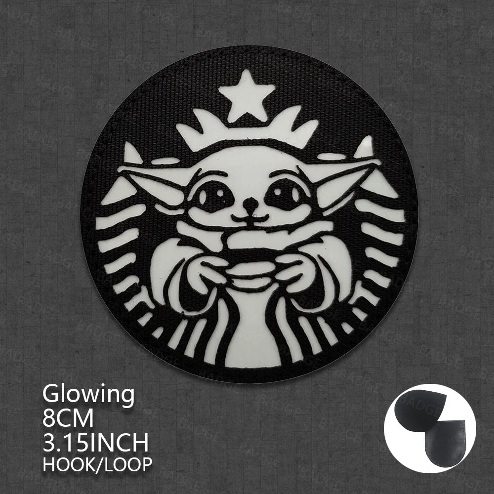 A round black patch featuring a white Star Wars Ewok head design with a crown and rays, intended for bags or vests.