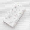 A white muslin swaddle blanket featuring a repeating pattern of cute animal designs on a striped background.