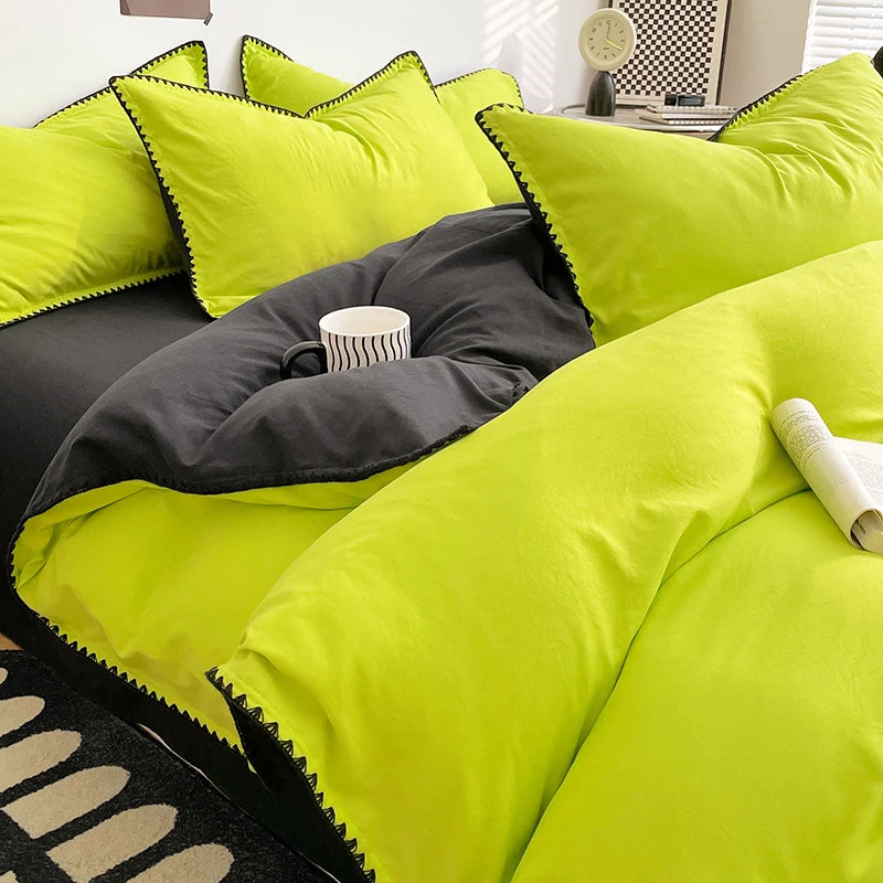 A bright lime green and charcoal gray bed linen set featuring pillows and a bolster cushion.