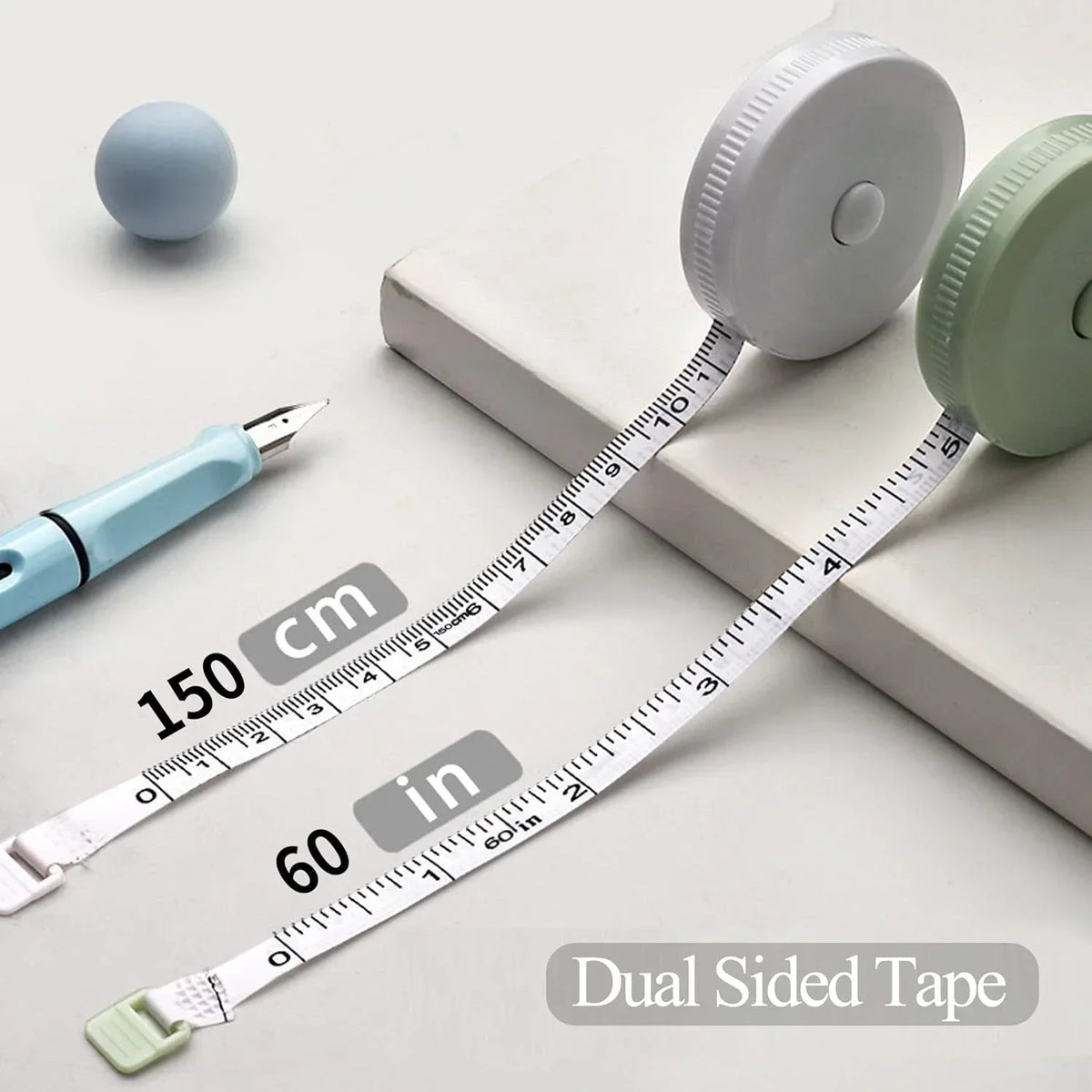A retractable double-sided measurement tape is shown next to a pen and a ruler, demonstrating its length in both centimeters 