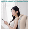 A woman is using an ergonomic memory foam wedge pillow for neck, back, and leg support while looking at a smartphone.