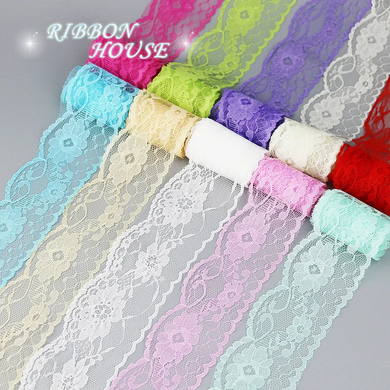A colorful roll of decorative lace ribbon featuring various shades including pink, purple, green, and blue.