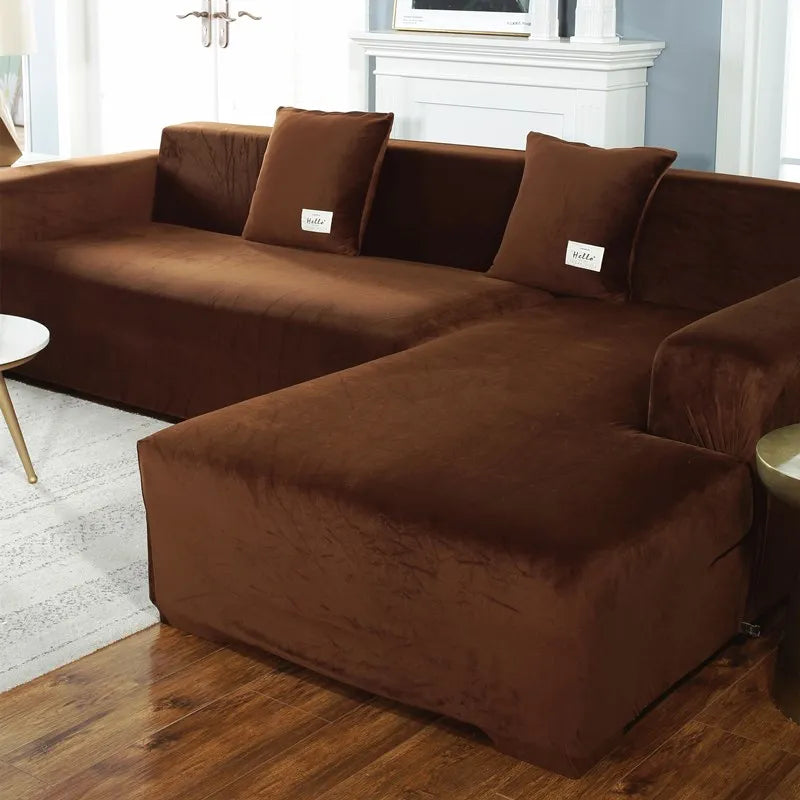A deep brown velvet sofa cover for an L-shaped sectional sofa in a living room setting.